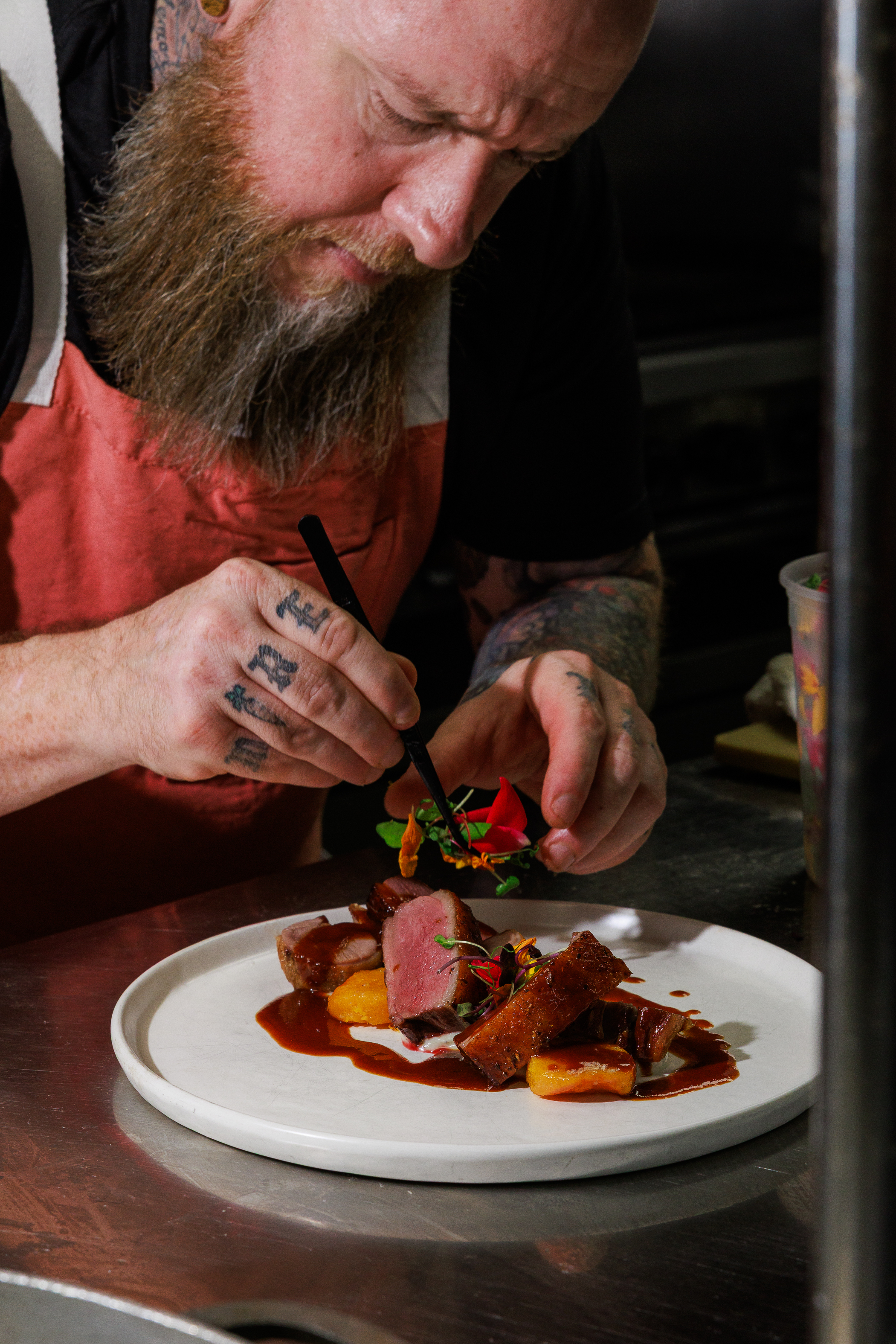 Chef plating duck breast at Salty Zebra Bistro Jupiter