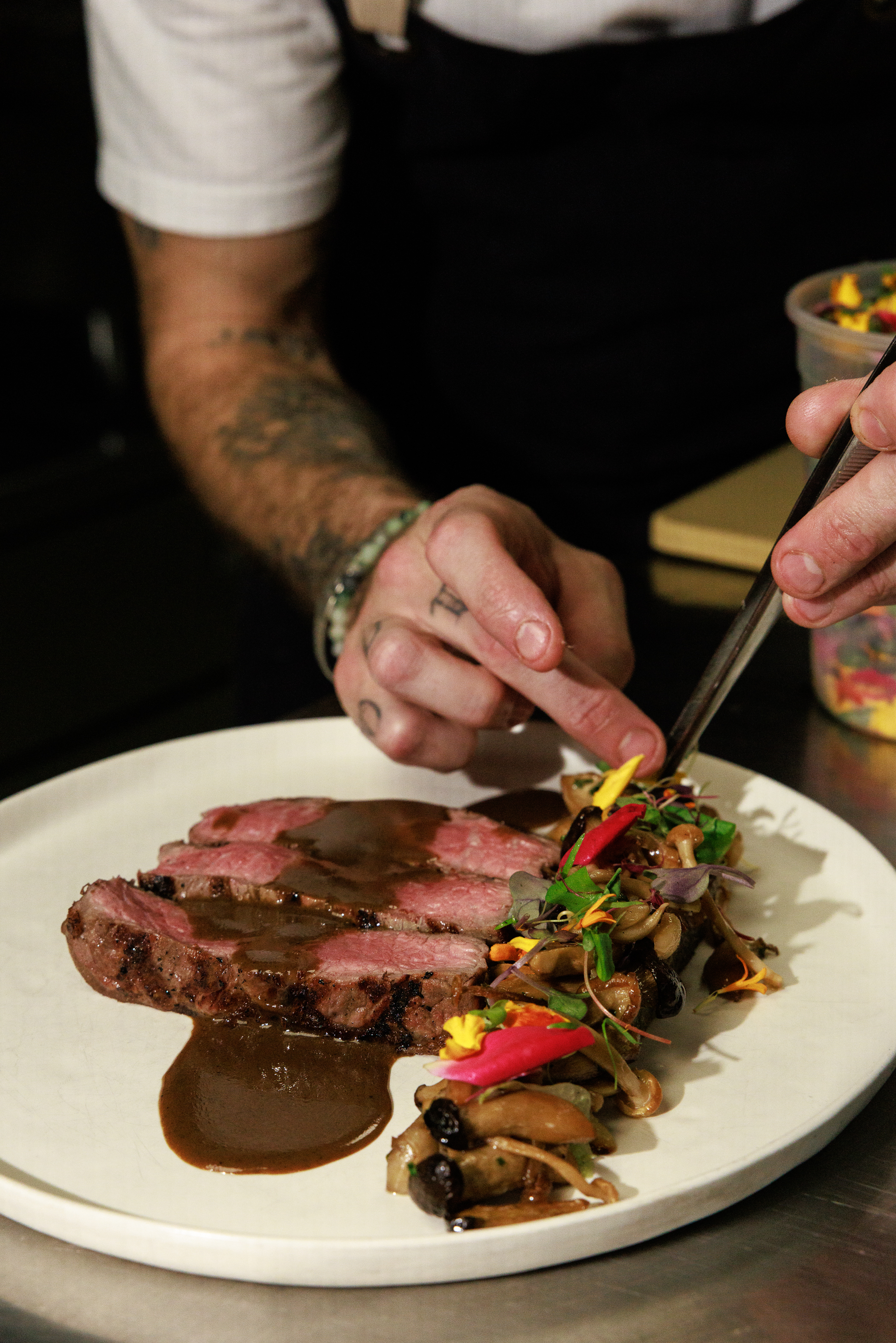 Chef plating steak at Salty Zebra Bistro Jupiter