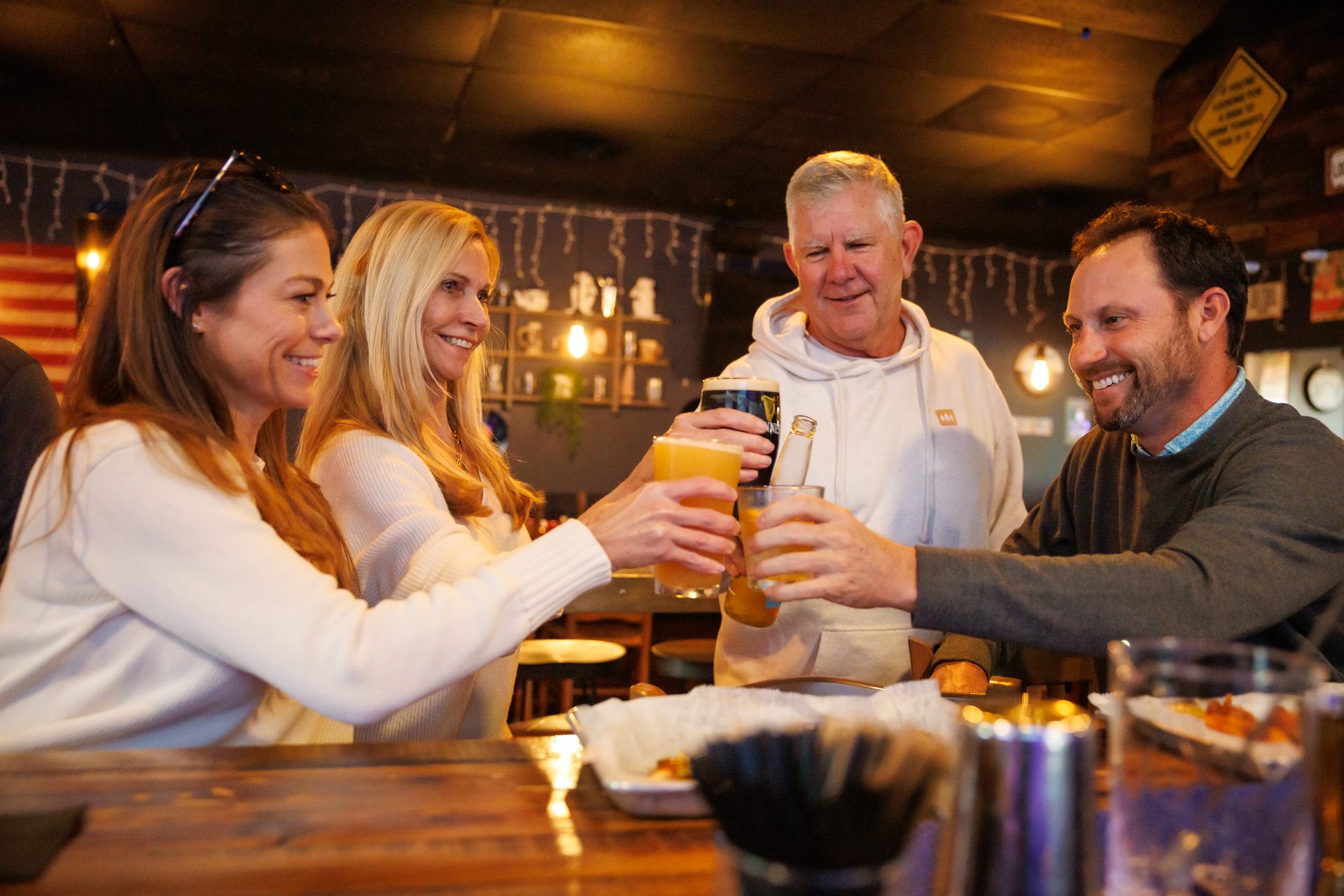 Friends cheering at Locals Pub late night